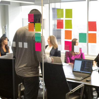 View into an office with sticky notes on the window.